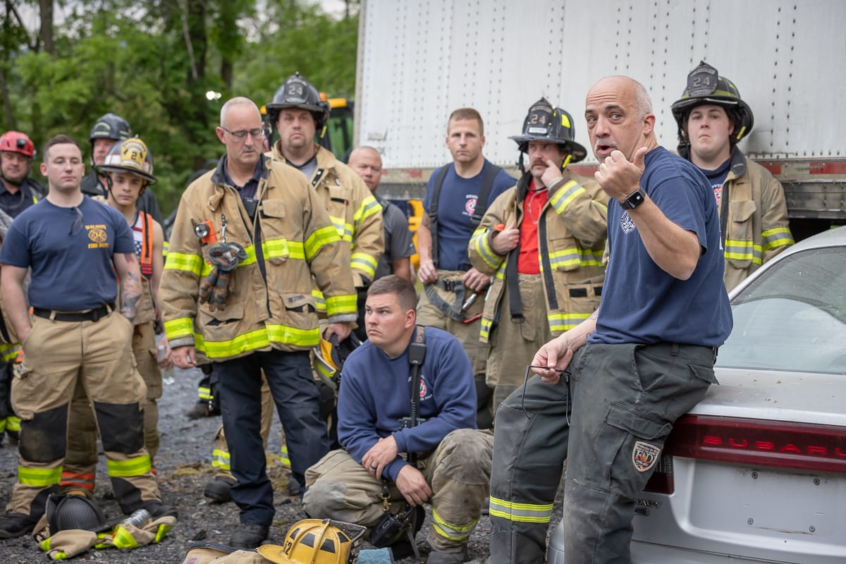 Ken Sobieski (center, sitting on car) talks with firefighters at a training event in Palmer Township on May 25, 2023.