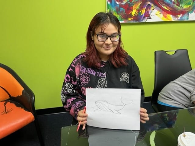 Building 21 High School senior Jorielys Ramos shows her sketch.