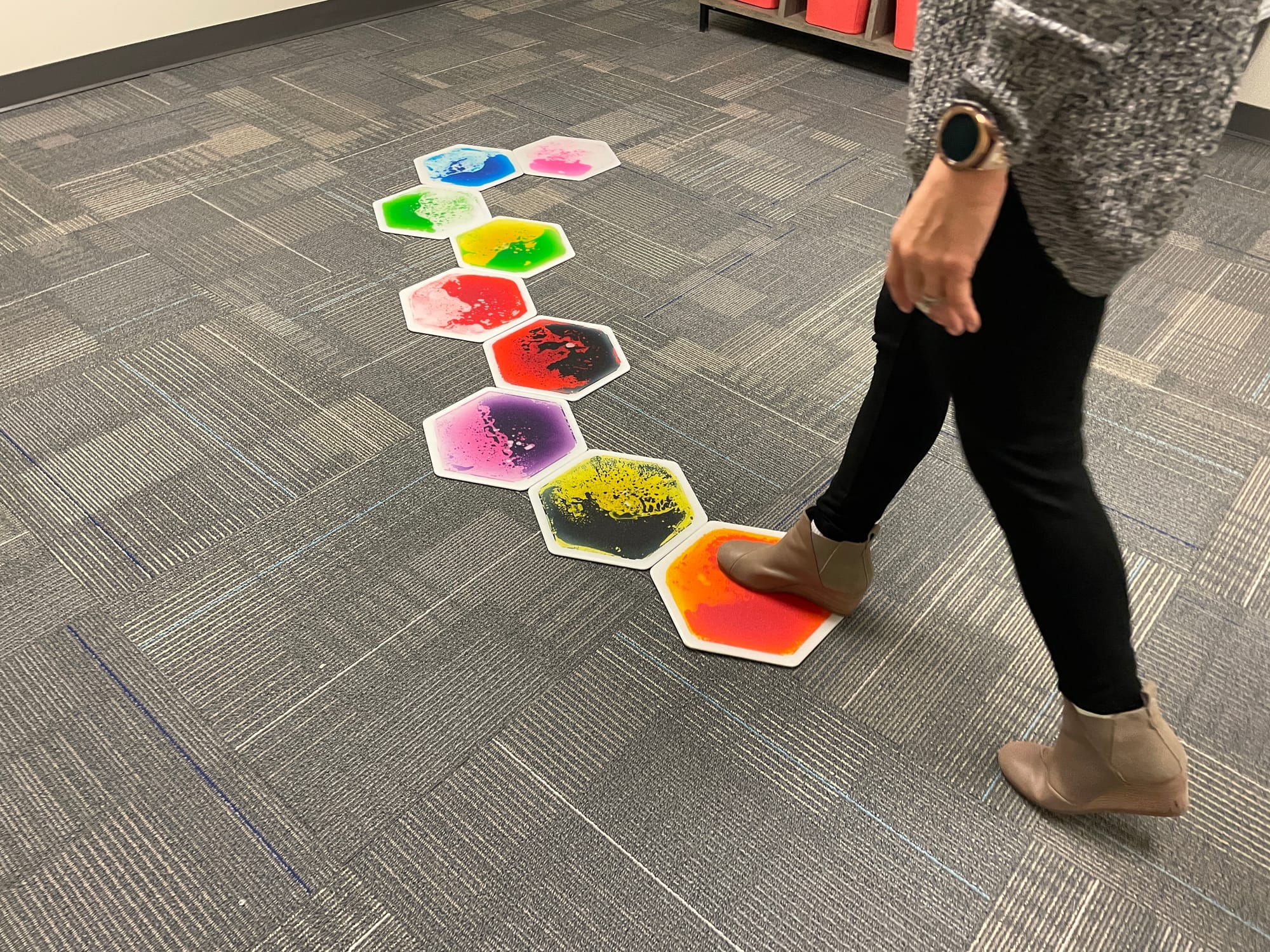 A staff member of the clinic demonstrates a tool in the sensory room. It is essentially to help kids satisfy their desire for