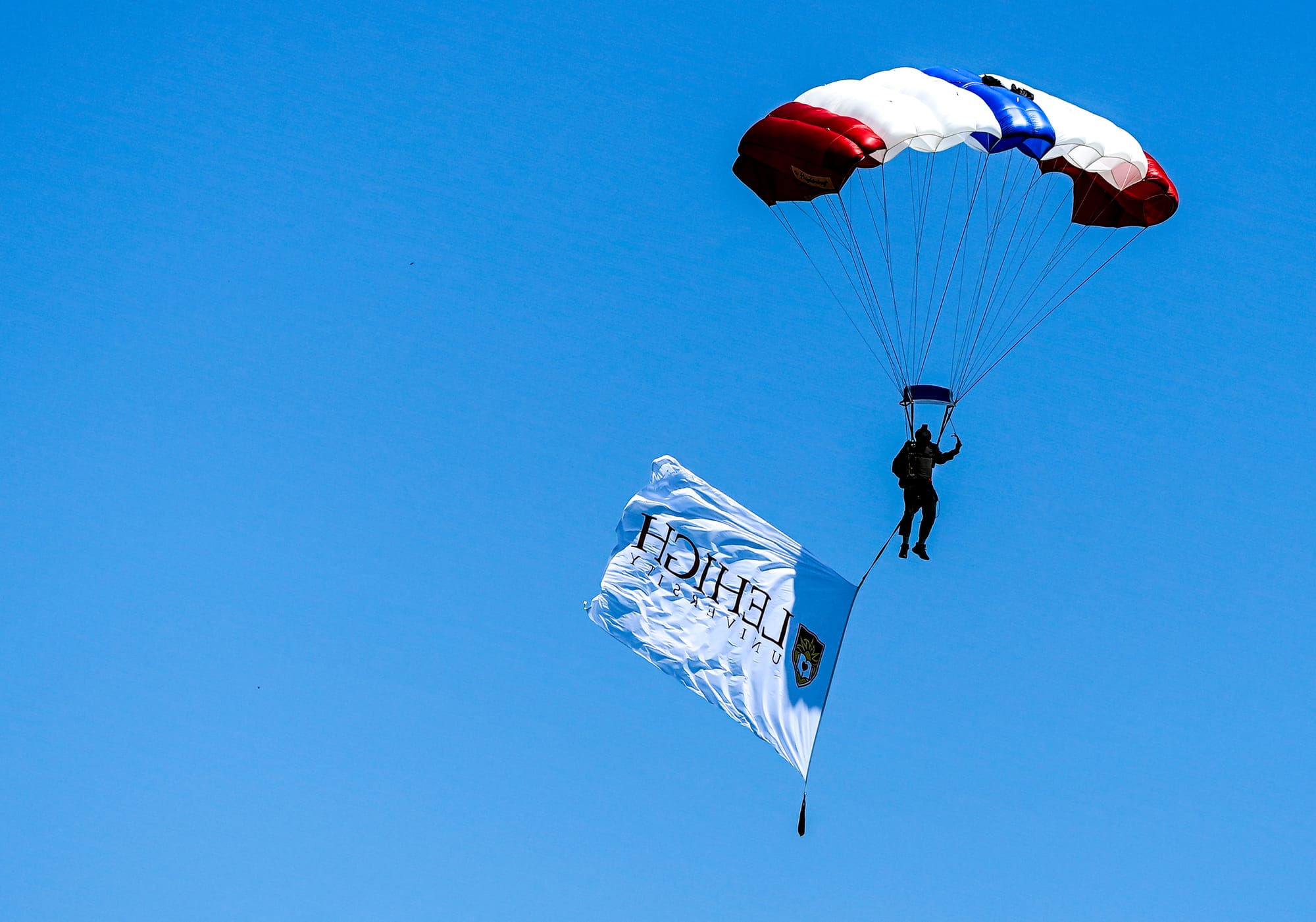 U.S. Special Forces members including U.S. Navy SEALs skydive from 4,000' onto the field near Goodman Stadium at Lehigh Unive