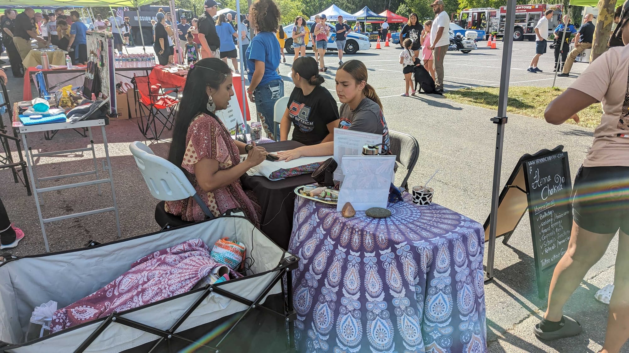 Visitors get Henna Body Art from Henna Chakra at National Night Out at Cedar Beach Park in Allentown.