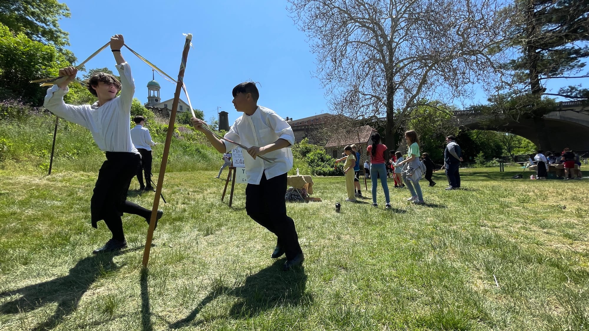 Students demonstrate how colonials would have used the maypole as part of a broader "Toys and Games" exhibit.