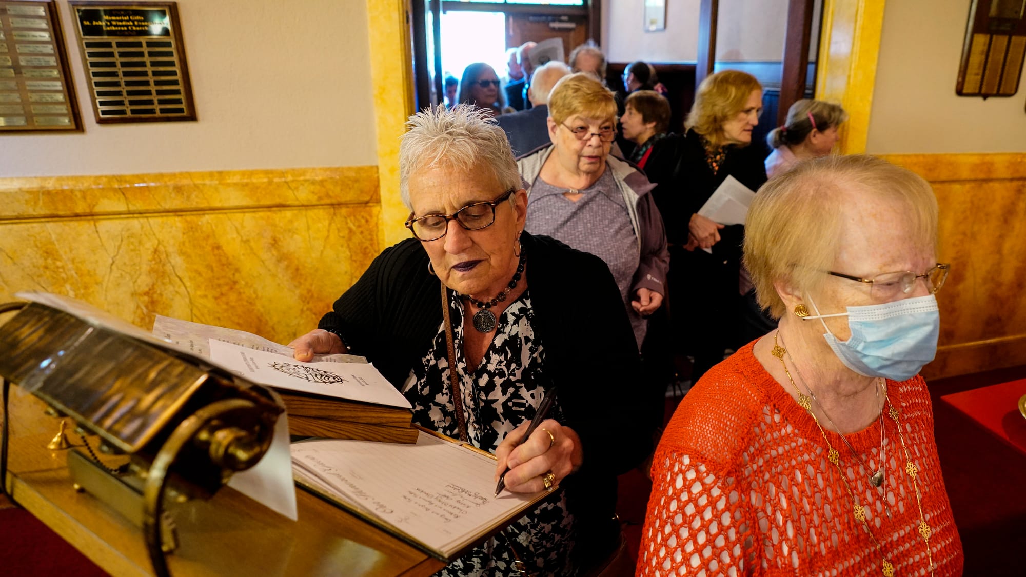 Guests sign the guest book as they enter. A Thanksgiving and Leave-Taking service was held at St. John's Windish Evangelical 