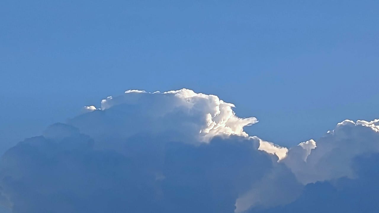Sunrise through clouds building over Allentown on Friday, July 14, 2023.