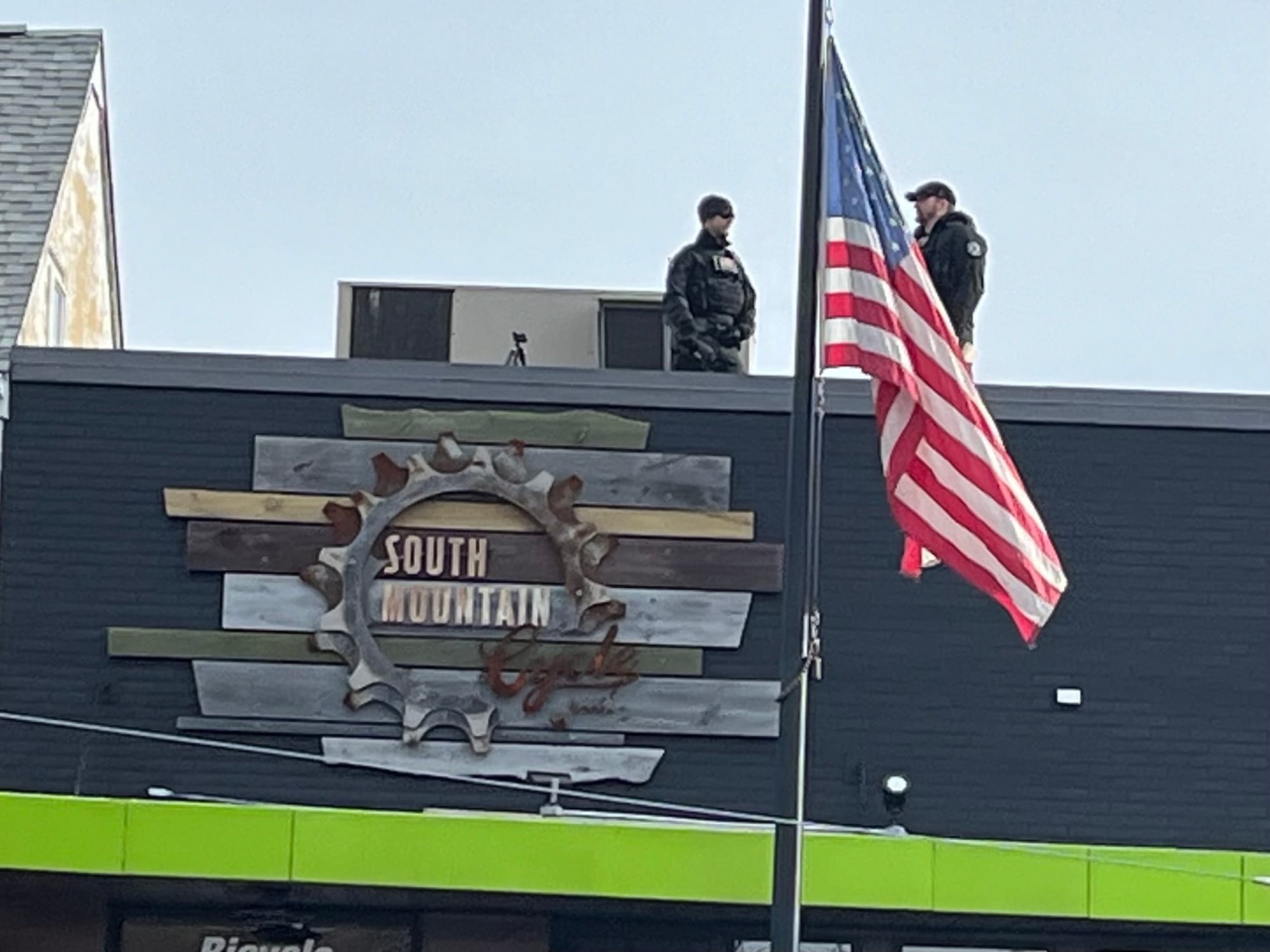 Marksman positioned on roof of South Mountain Cycle on Main Street in Emmaus awaiting the arrival of President Biden.