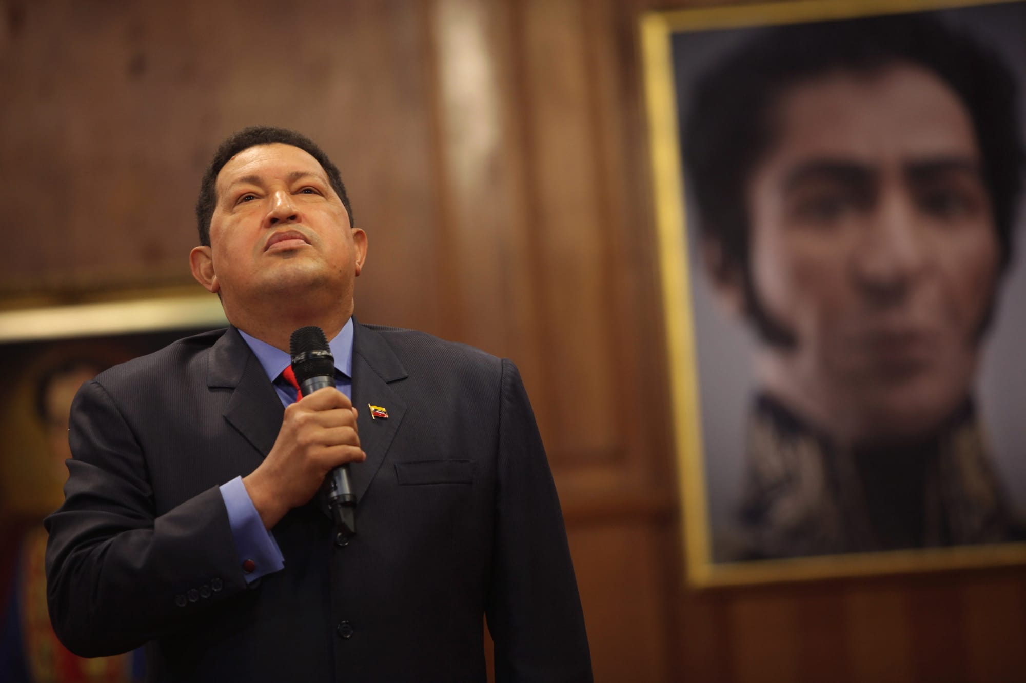 Standing next to a portrait of independence hero Simon Bolivar, Venezuelan President Hugo Chavez speaks during a press confer