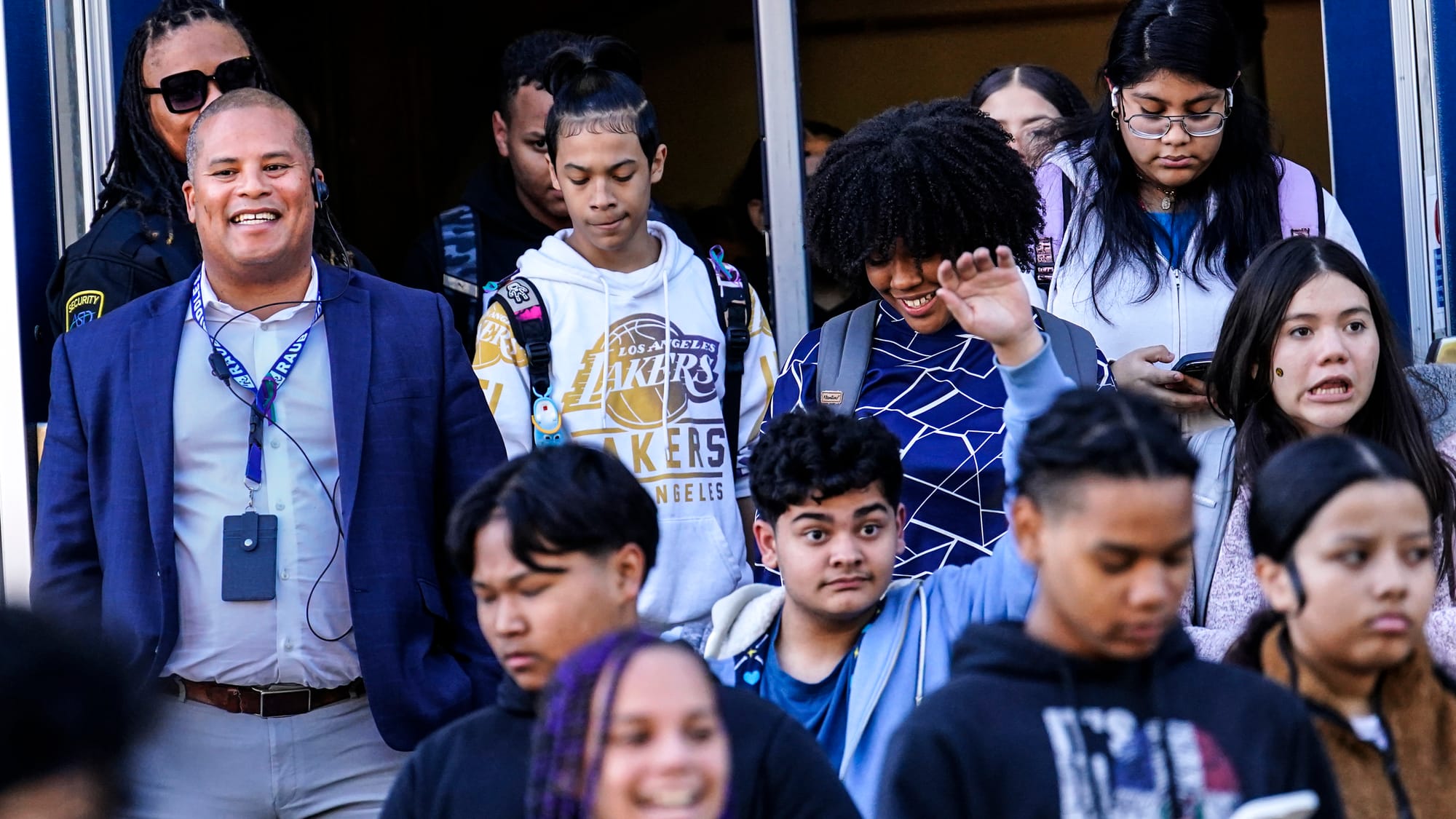 Principal José Delgado, left, watches students head home from Raub Middle School in Allentown, Pa. on Thursday, October 17, 2