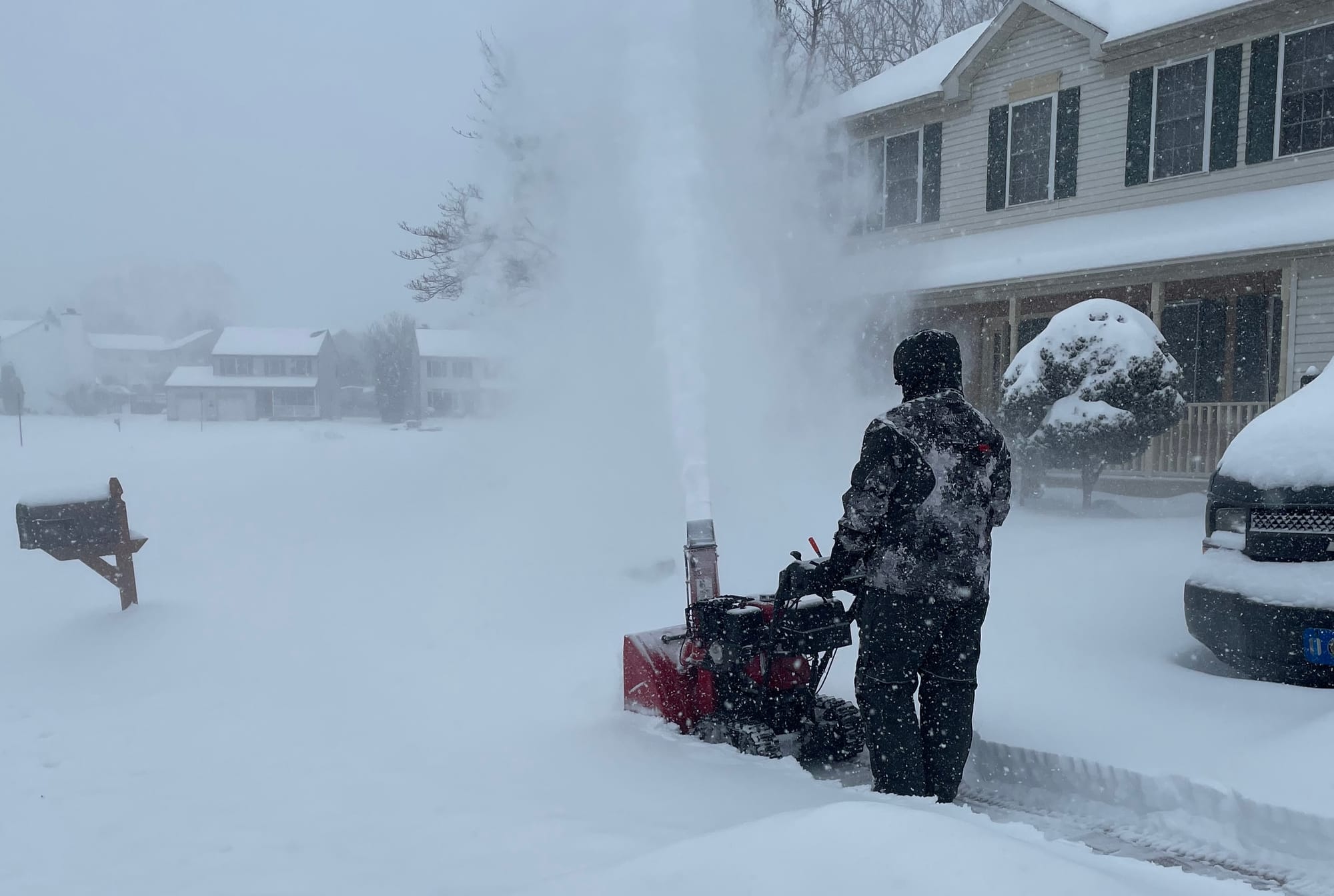 A resident uses a snowblower to clear a walkway along Forest Line Road in Palmer Township, shortly after noon on Sunday, Jan.
