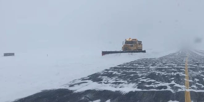 A plow clears the runway at Lehigh Valley International Airport on Sunday during record-setting snowfall.