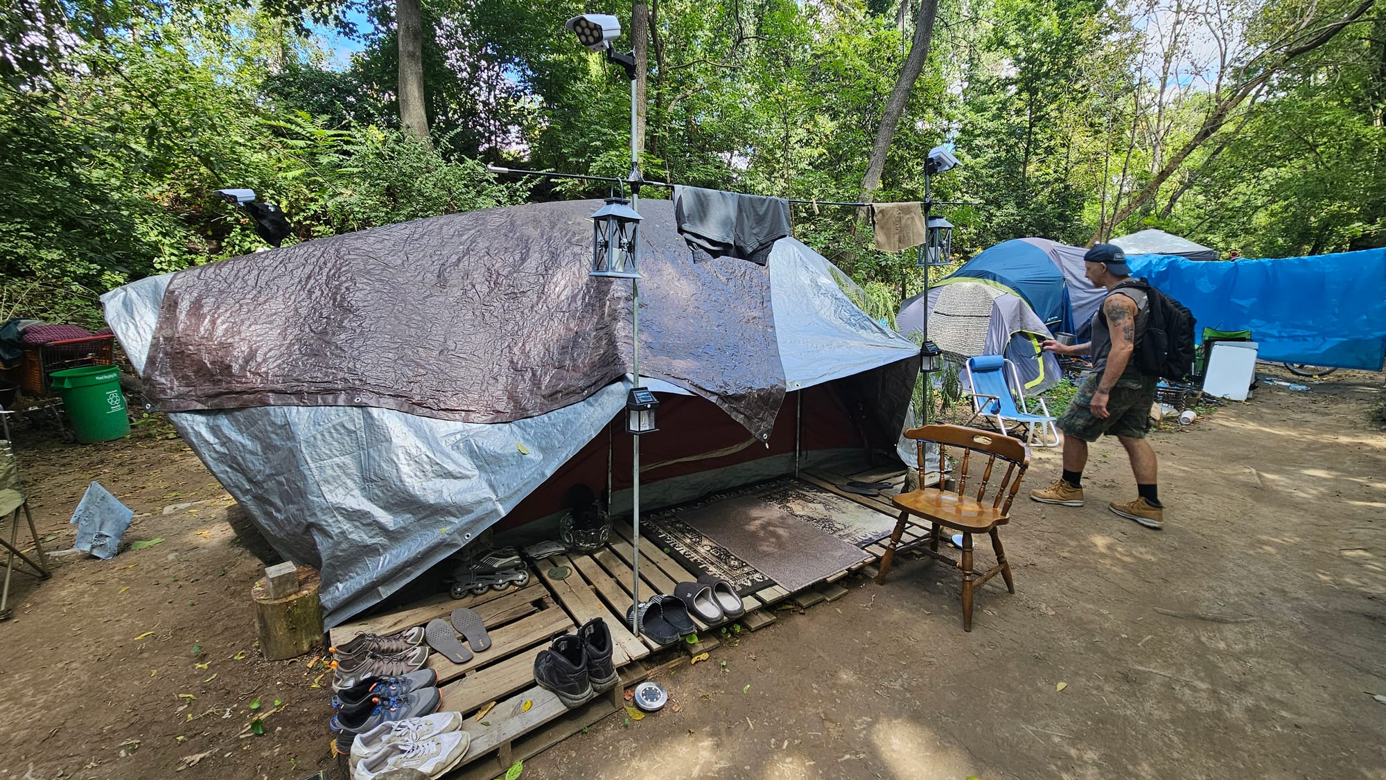 Sonny, a resident of the encampment along the Jordan Creek in Allentown, shows off his tidy tent Wednesday, Aug. 27. He's con