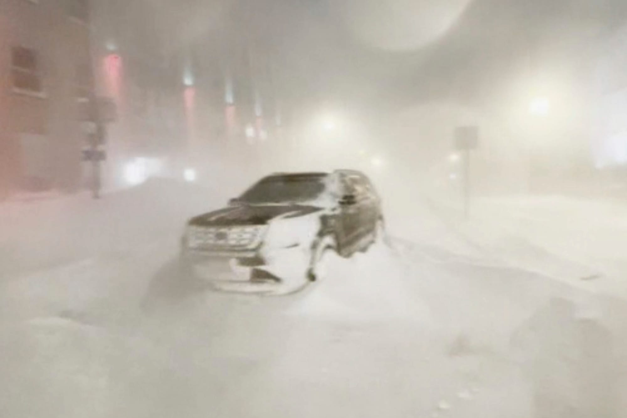 High winds and snow covers the streets and vehicles in Buffalo, N.Y. early Sunday, Dec. 25, 2022. Millions of people hunkered
