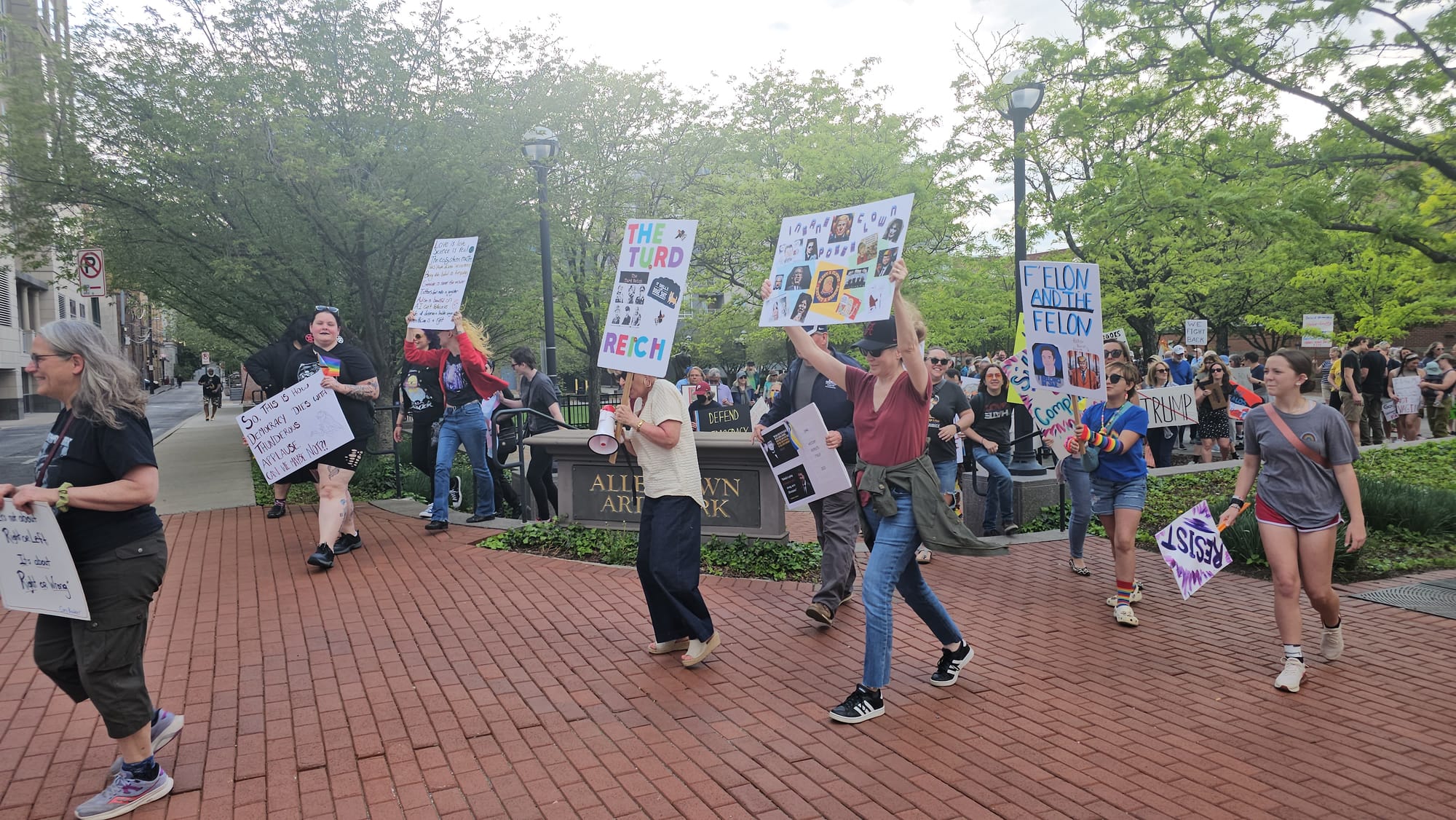 Protesters walk out of the Allentown Arts Park on Thursday, May 1.