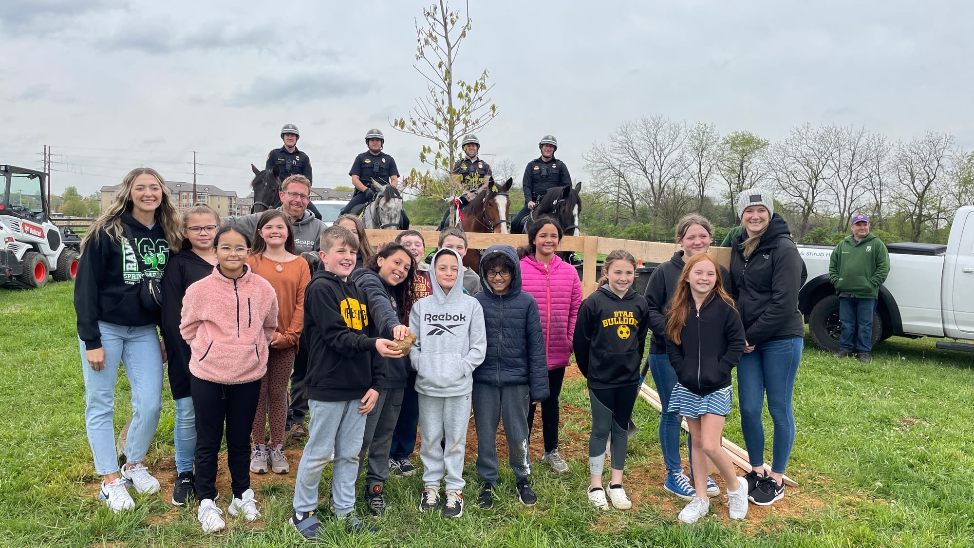 Spring Garden Elementary students stand next to their newly planted tree.