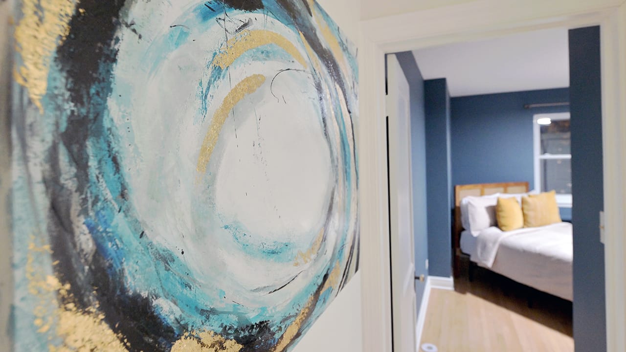 Artwork hangs on a wall in a West Bethlehem home designed by Wandra Cain.
