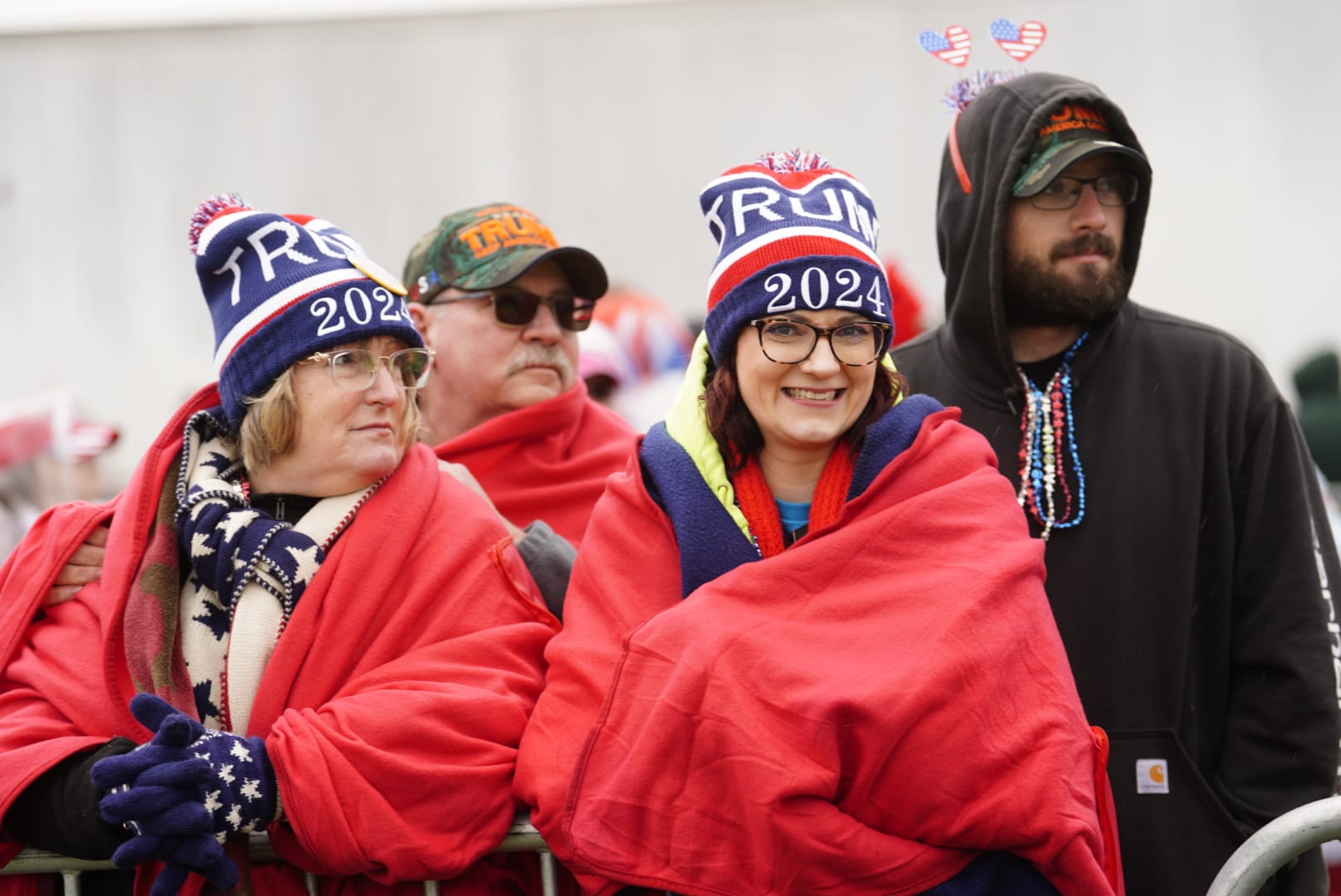 Trump supporters donned head to toe in red, white and blue as they stand in line for the former president's rally.