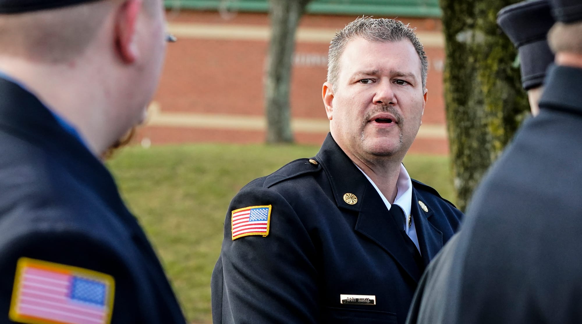 New Tripoli Fire Chief Gary Kuntz, Jr. speaks to his firefighters. Mourners gather at Northwestern Lehigh Middle School in Ne