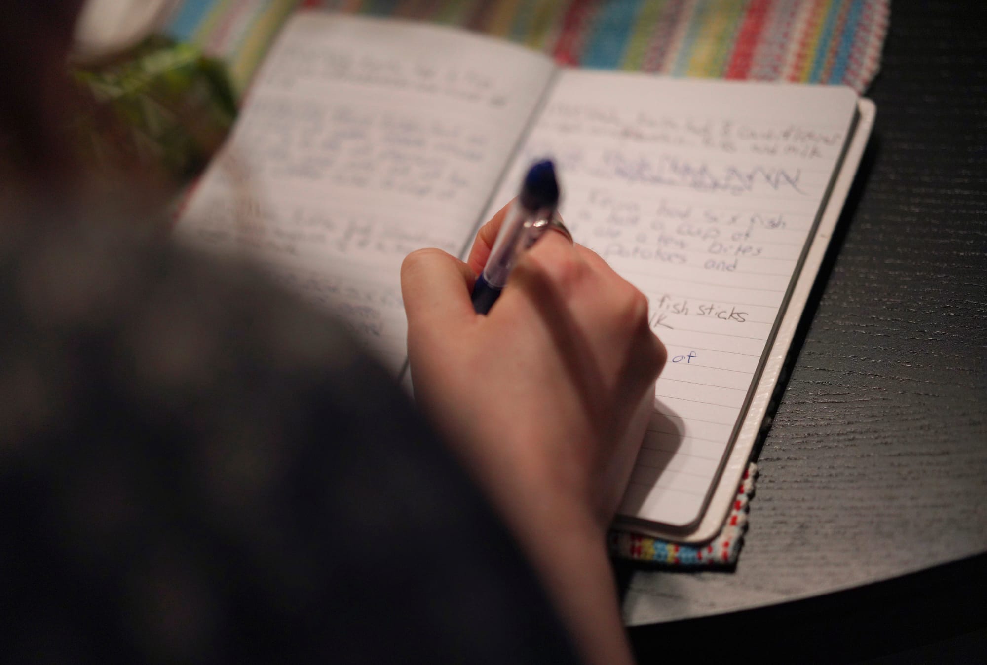 Lauren Hackney makes a note of what her 1-year-old daughter ate for dinner during a supervised visit at their apartment in Oa