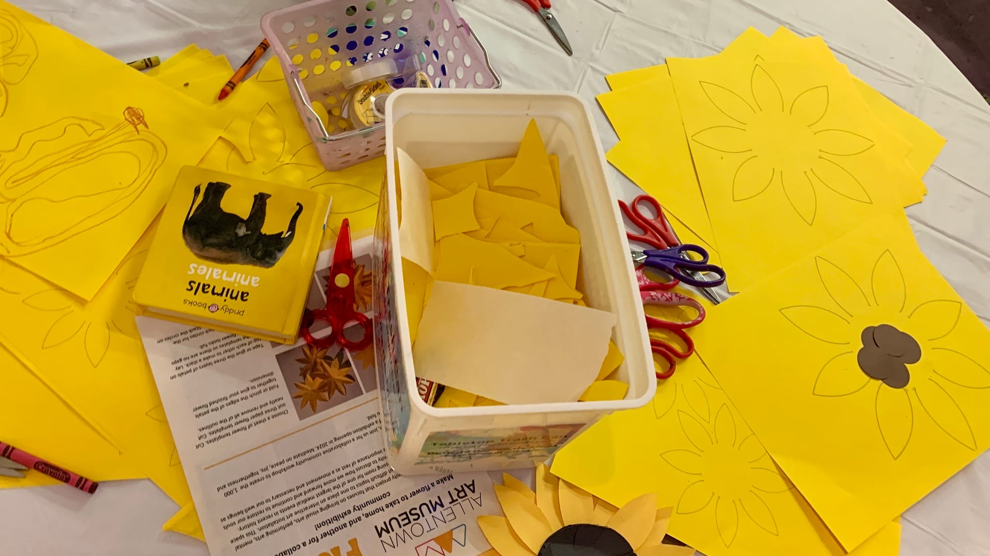 Materials to make paper sunflowers at the 'Restoring Petals' exhibition.