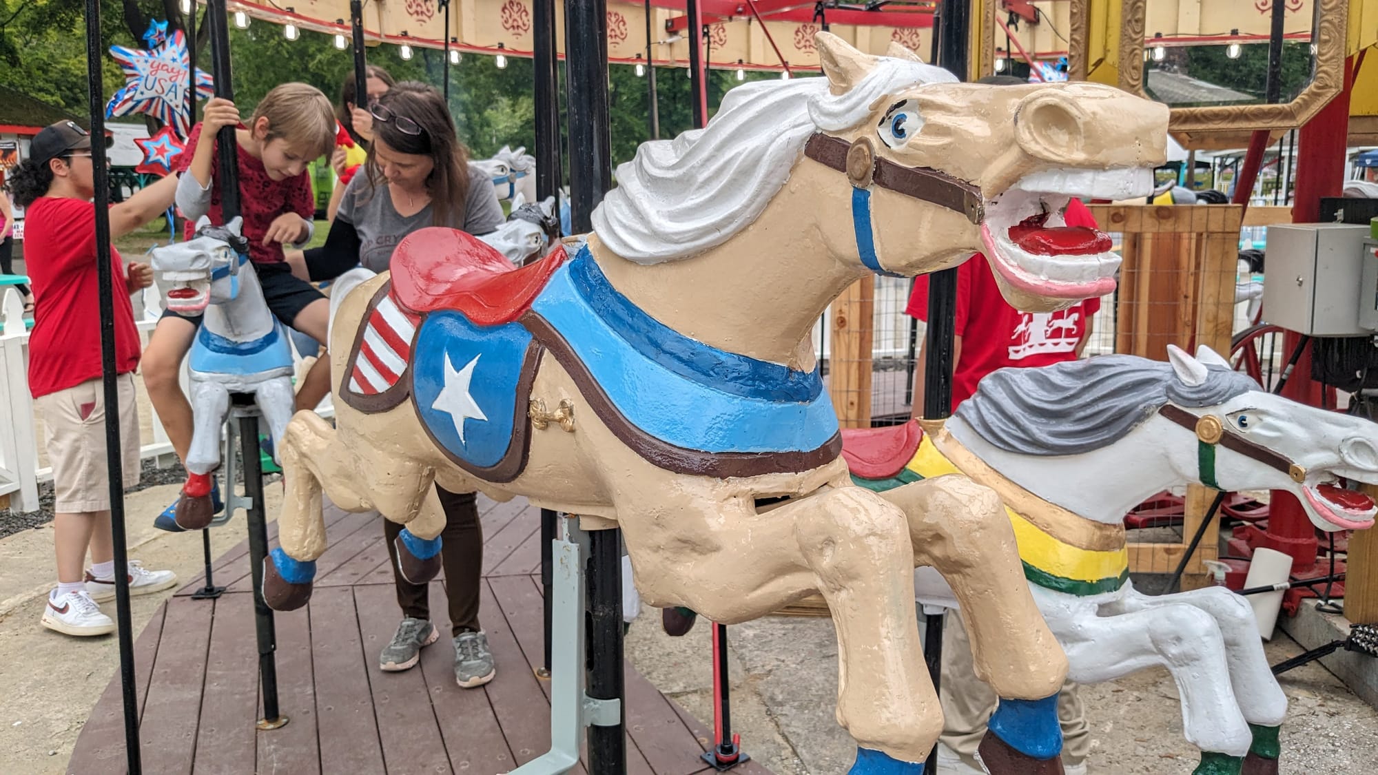 Some of the Bushkill Park's first riders on its new carousel, built in 1928, prepare to start moving Sunday afternoon.