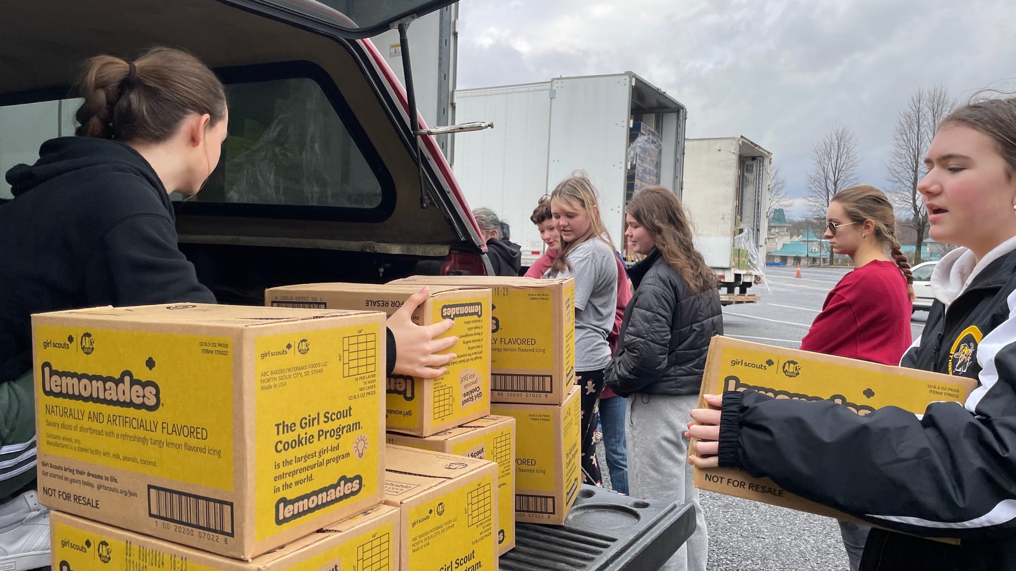 Lily Kinnon (right) brings over a box of Lemonades, as Girl Scout Troop 6741 of New Tripoli prepares for the incoming season 