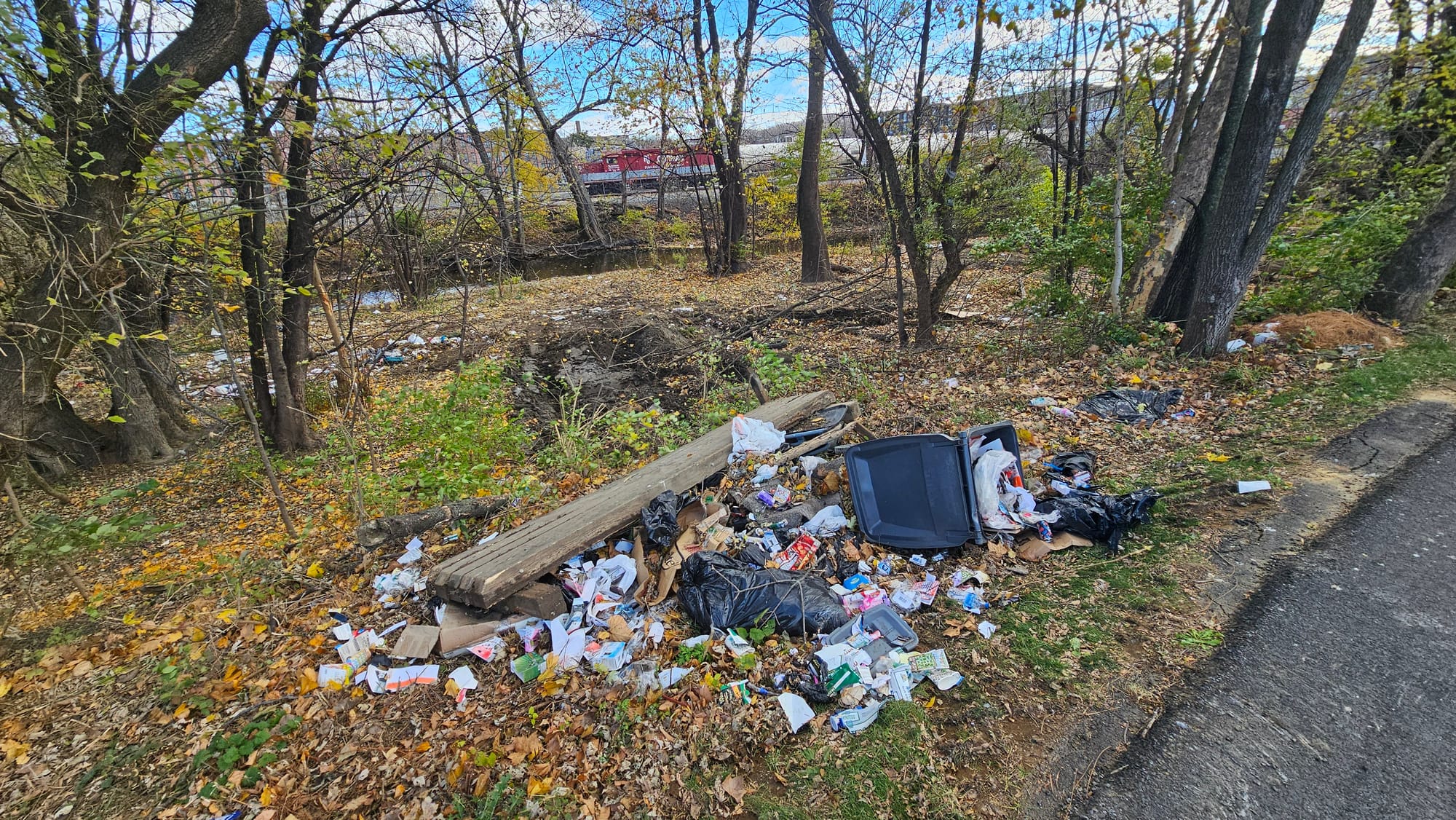 City crews made piles of trash and debris to be thrown into dumpsters as they cleared the Jordan Creek Greenway encampment Mo