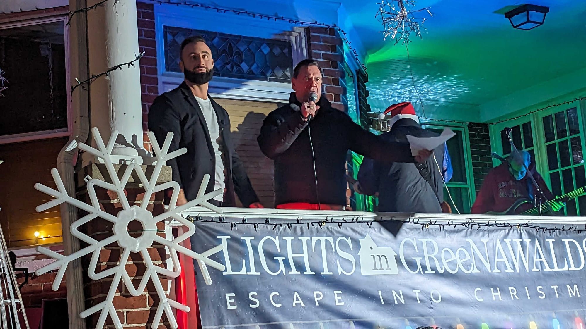 Mike Yellak, left, and Mike Mittman (with microphone) during the Lights in Greenawalds Opening Night. The Common Bond band is