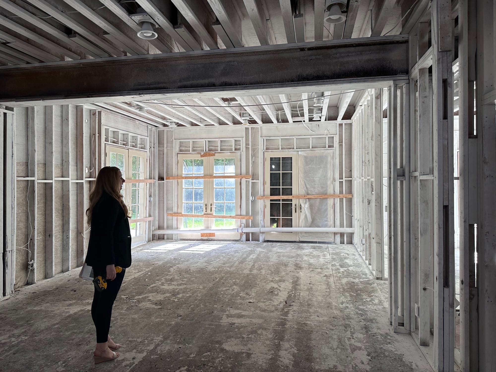 Michelle Hunsberger, a realtor with Tranzon/Sanford Alderfer Real Estate, stands in what appears to be labeled as a lounge ro