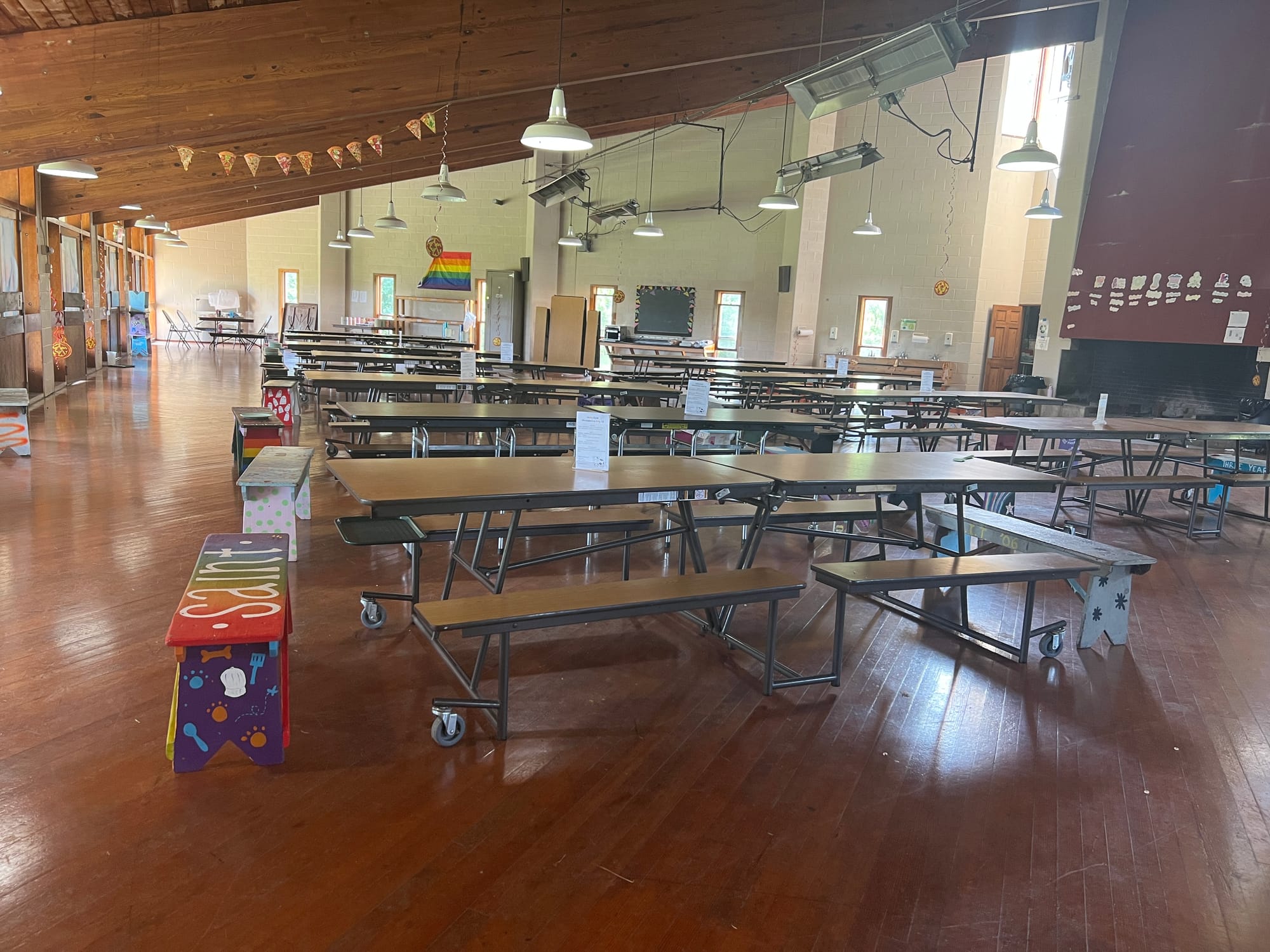 The dining hall seats eight girls to a table, with a staff member sitting on a bench at each end. It is a tradition that grou