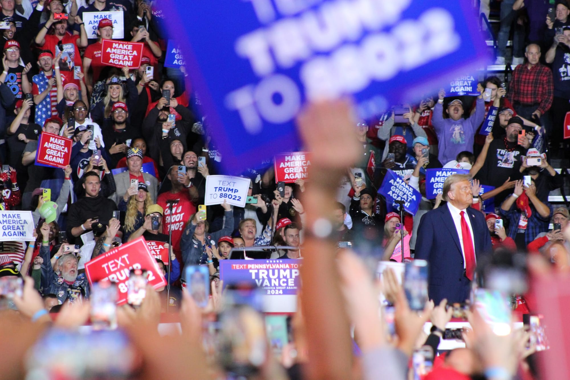 Former President Donald Trump takes the stage at the PPL Center during a Tuesday night rally in Allentown.