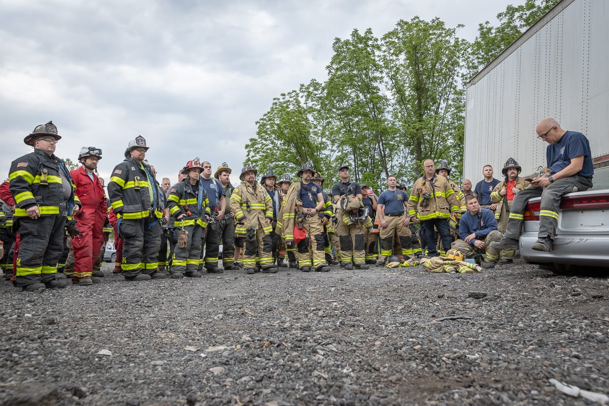 Ken Sobieski (center, sitting on car) talks with firefighters at a training event in Palmer Township on May 25, 2023.
