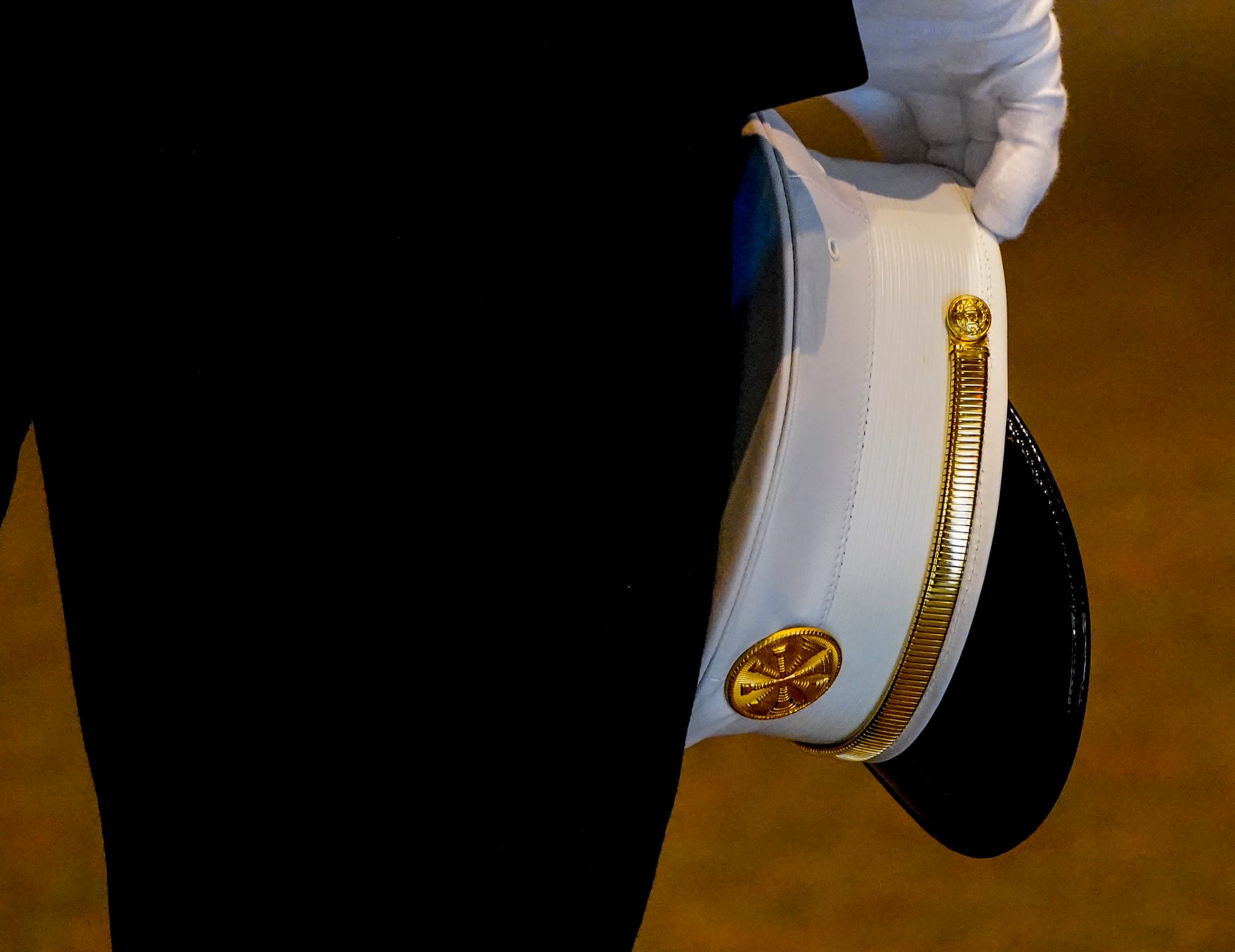 Fire Chief Gary Kuntz, Jr., holds his hat in the auditorium. Mourners gather at Northwestern Lehigh Middle School in New Trip