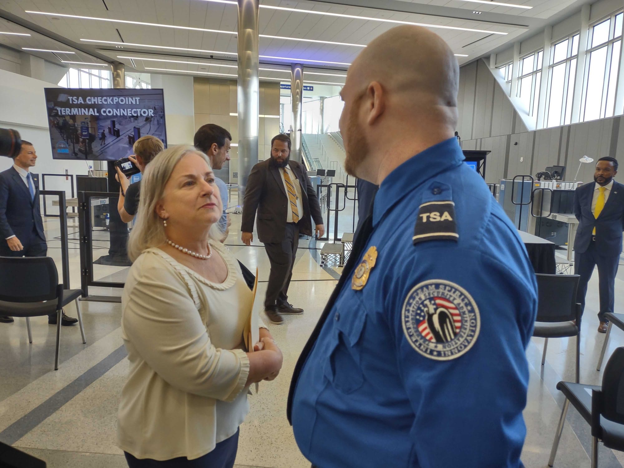 U.S. Rep. Susan Wild, D-Lehigh Valley, speaks with a TSA agent during the grand opening of a $35 million expansion at Lehigh 