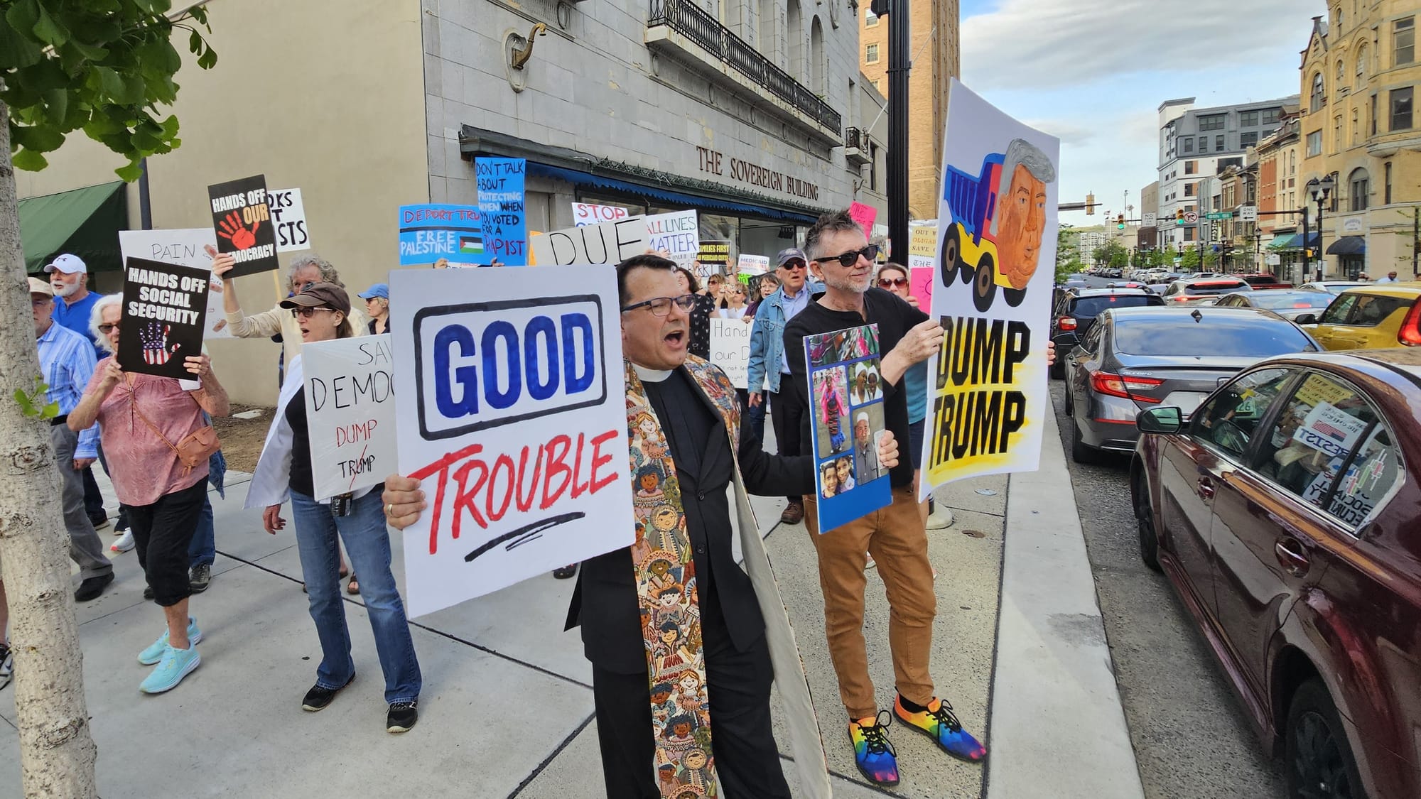 Rev. Steve Davis, senior pastor of St. John’s UCC Fullerton in Whitehall, leads a chant as protesters pass by the Da Vinci Sc