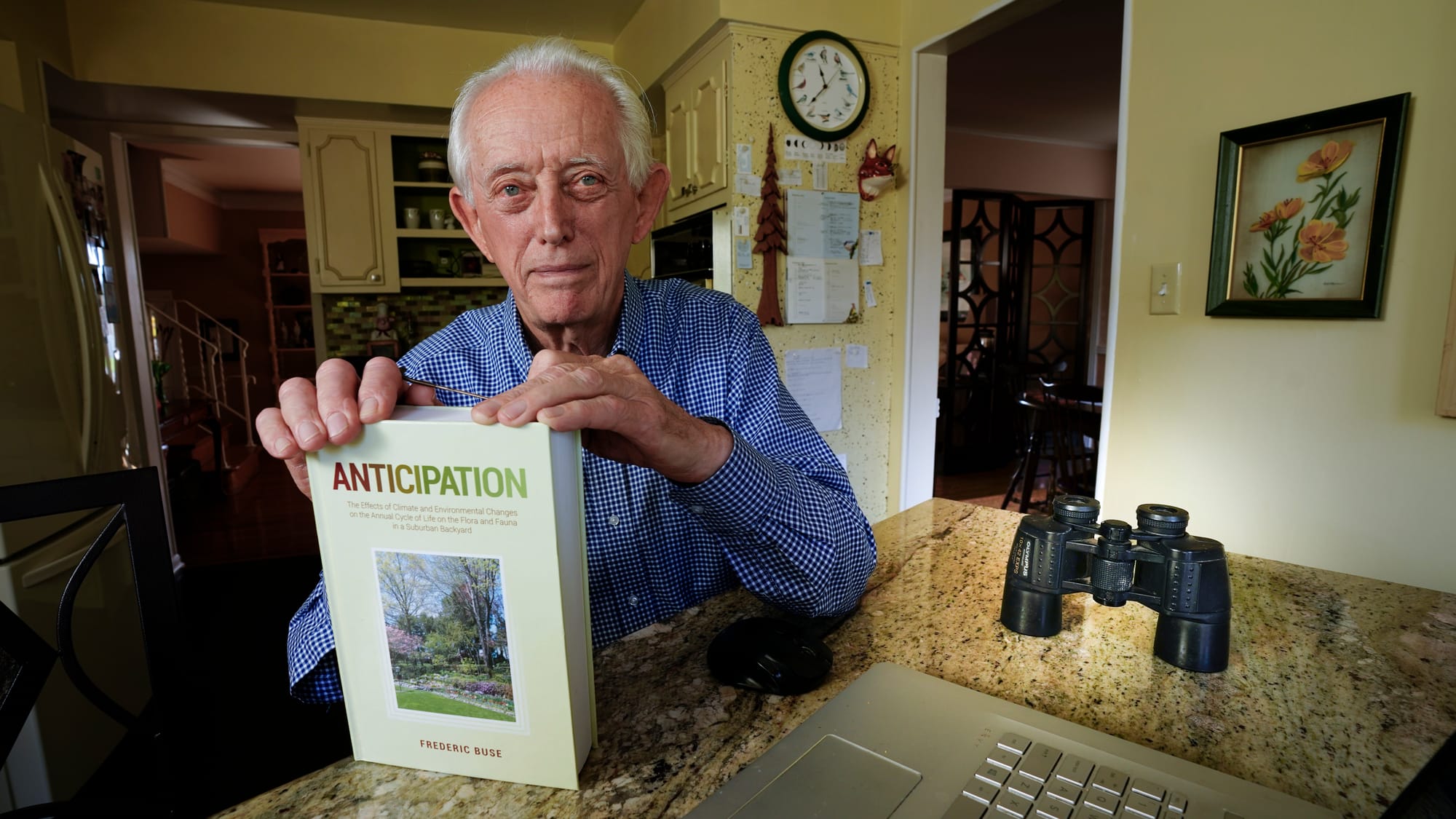 Fred Buse sits at his kitchen table with his book Anticipation. Fred Buse, 87, of South Whitehall Township, has been tracking