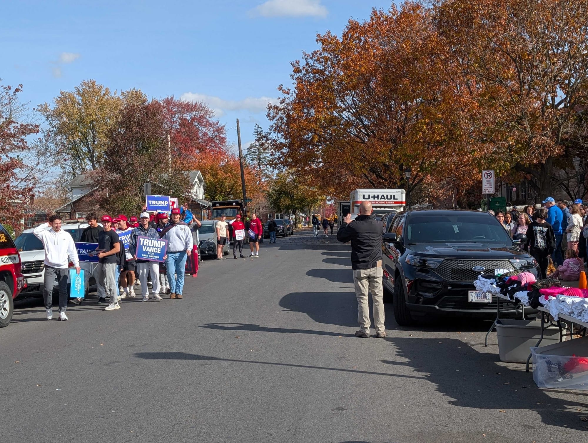A small group of Donald Trump supporters opposite a line of Kamala Harris supporters outside a rally for the Vice President a