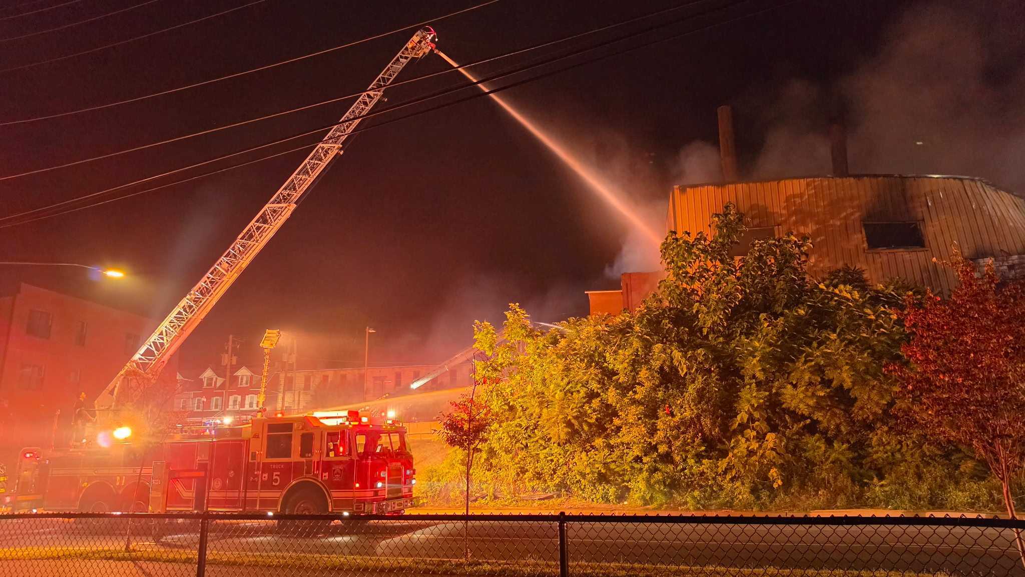 Allentown firefighters battle a massive fire Wednesday night at a former industrial building near the city's riverfront.