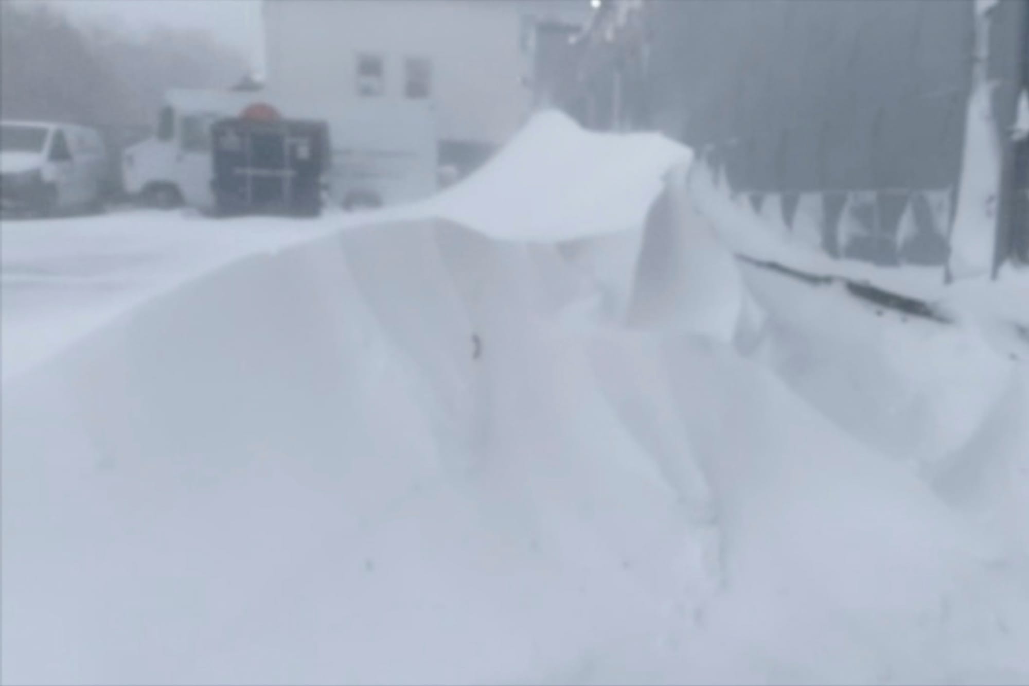 High winds and snow covers the streets and vehicles in Buffalo, N.Y. on Sunday, Dec. 25, 2022. Millions of people hunkered do