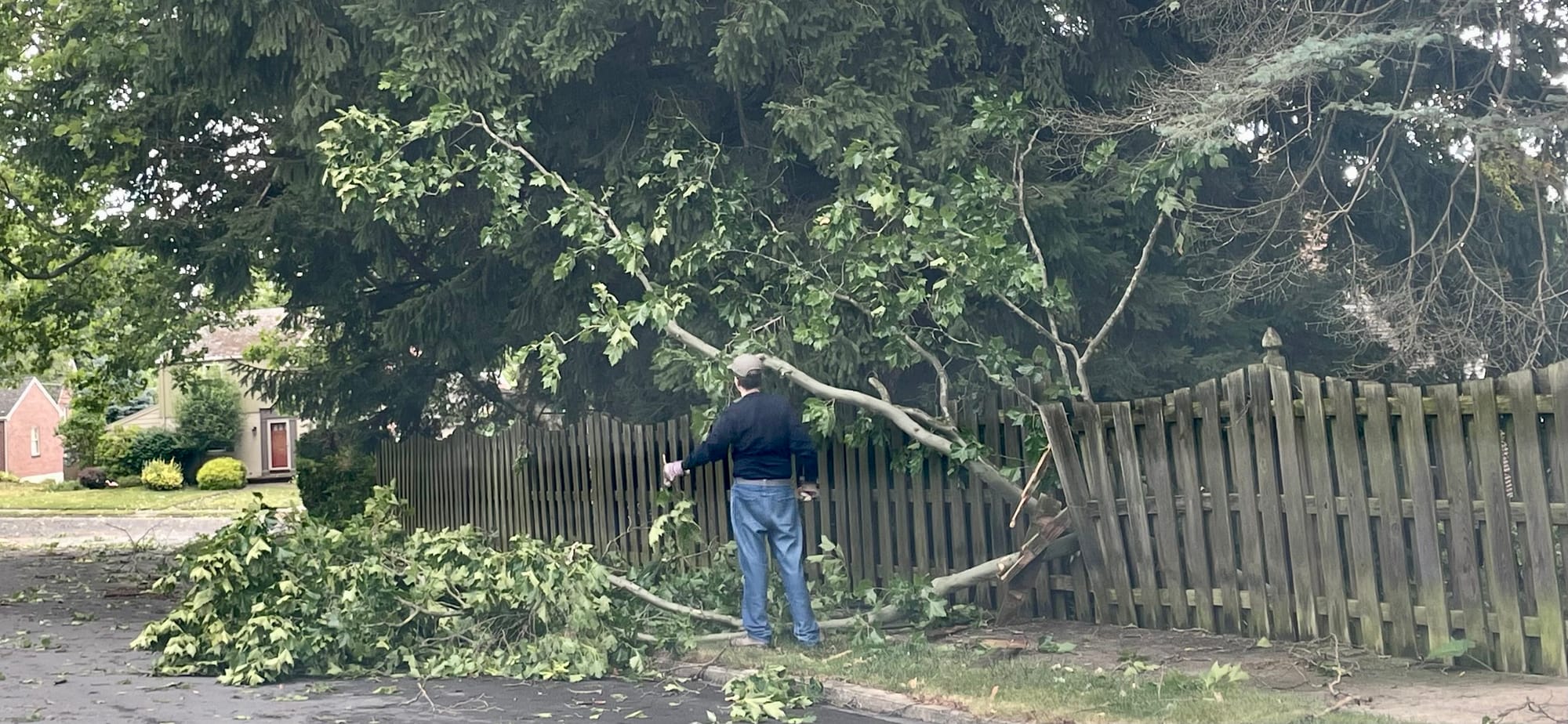 A homeowner on Homestead Ave in Bethlehem cleans up after Wednesday's storm.