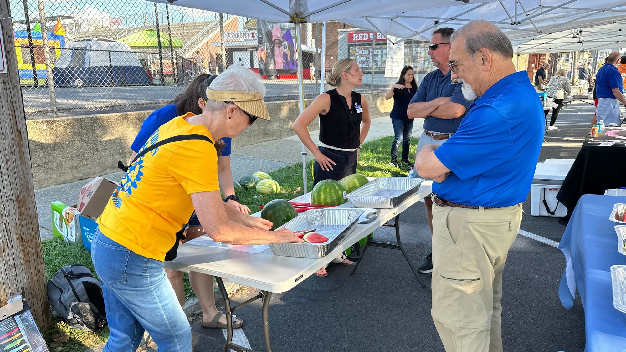 Cutting watermelon at Easton's National Night Out event at Paxinosa School.