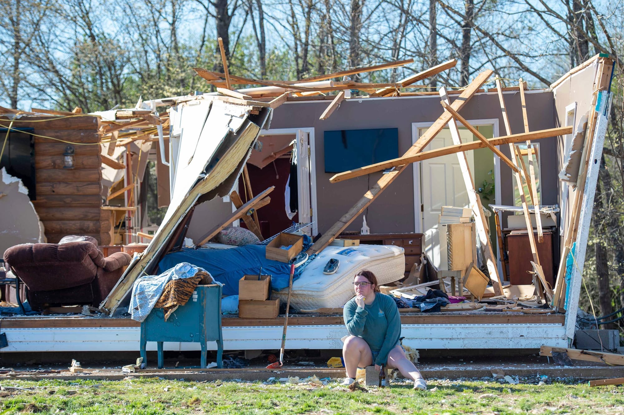 Regan Millmeyer sits in front of her tornado damaged home in Adamsville, Tenn. on Saturday, April 1, 2023. A series of storms