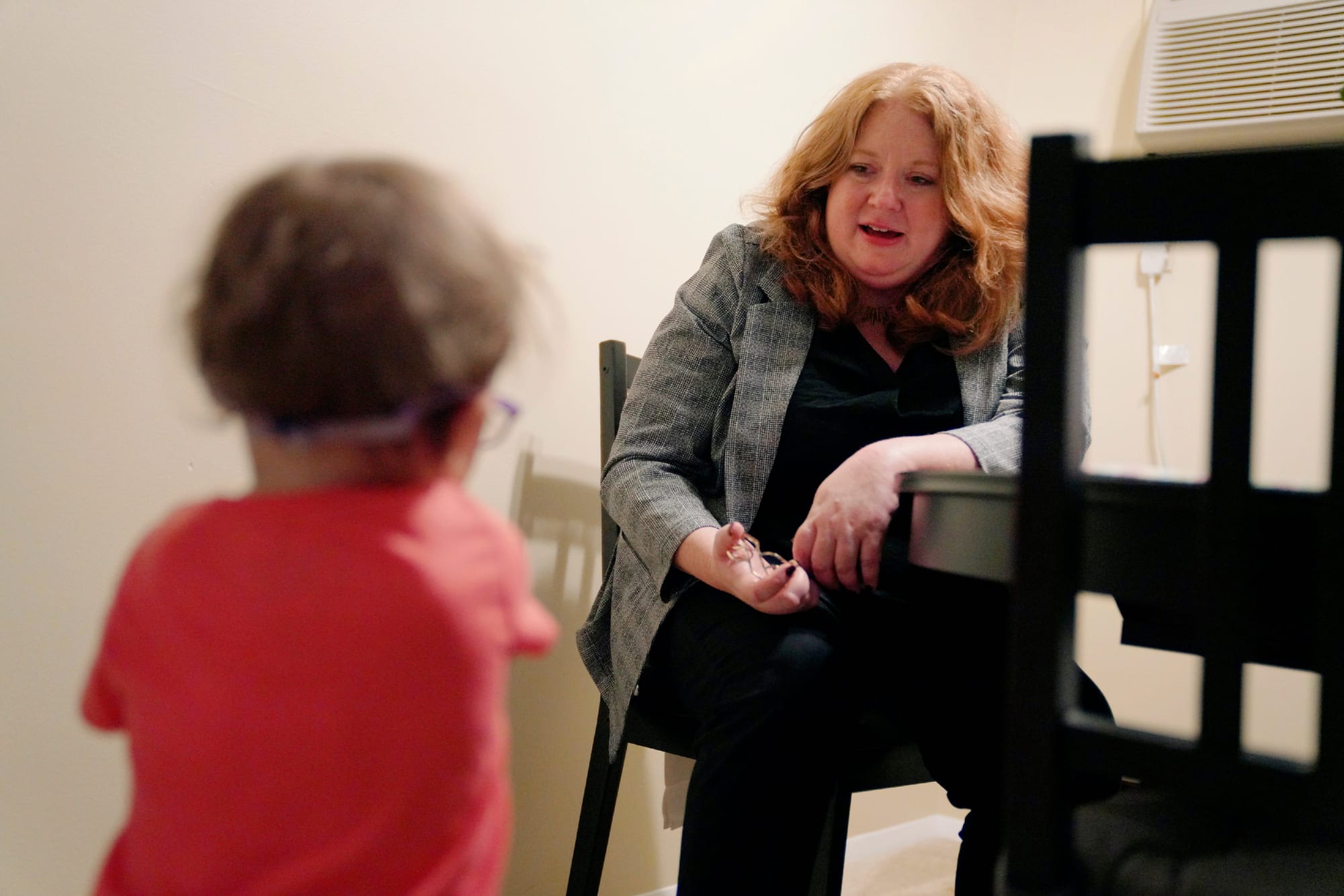 Robin Frank, a family law attorney in Pittsburgh, talks with her client, Andrew Hackney, and 1-year-old daughter during one o