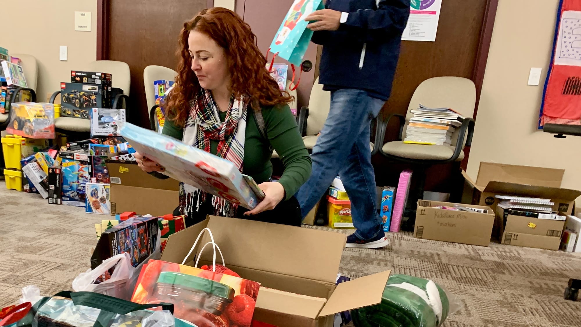 A volunteer unpacks toys for the KidsPeace Angel Tree holiday gift drive.