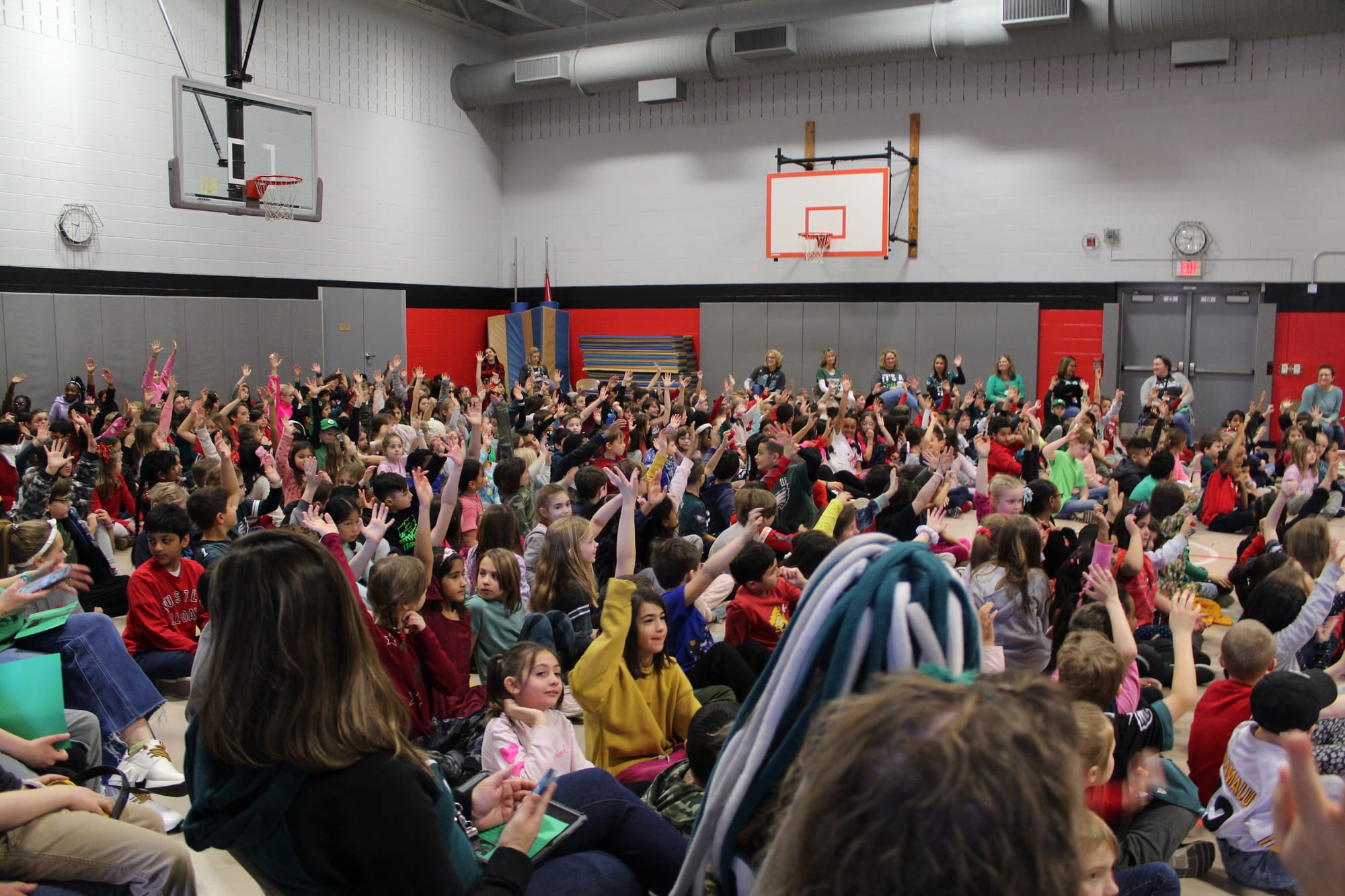 Students at Cetronia Elementary School raise their hands enthusiastically as they are asked who plans to watch the Super Bowl