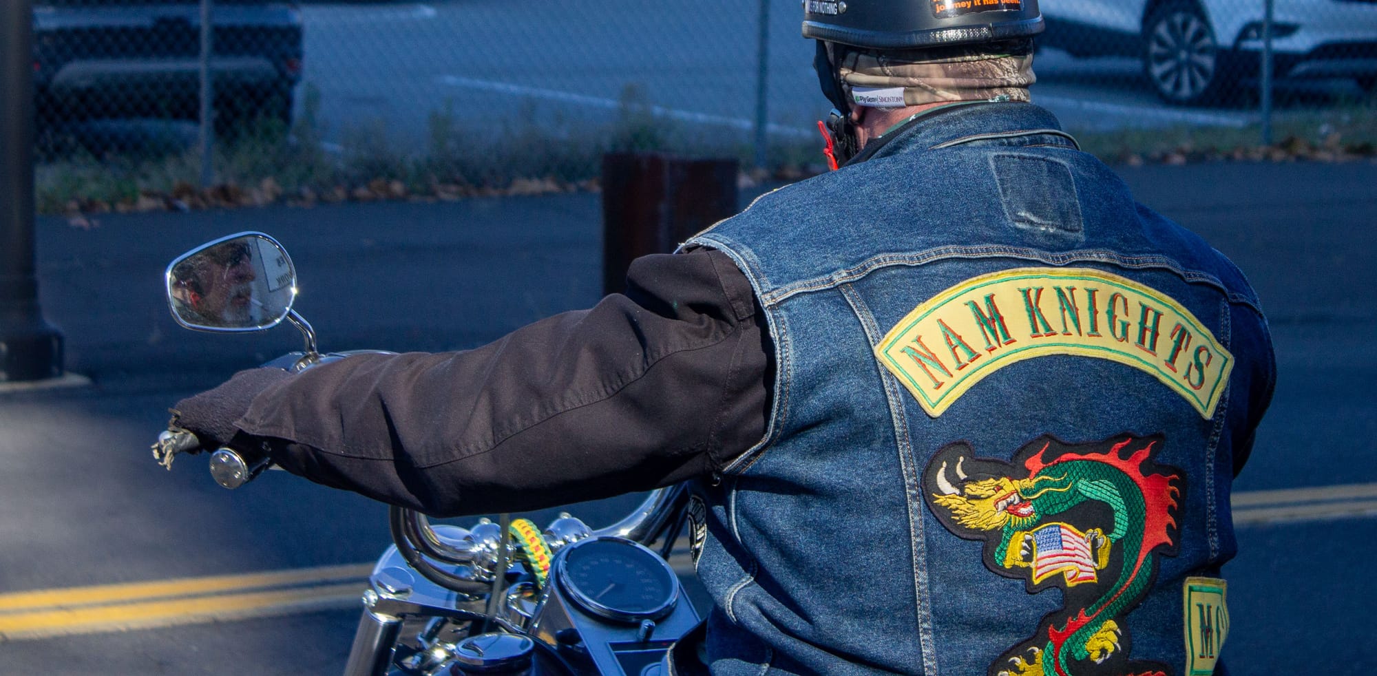 A member of the Nam Kings quietly sits for a moment before starting his engine after the ceremony.