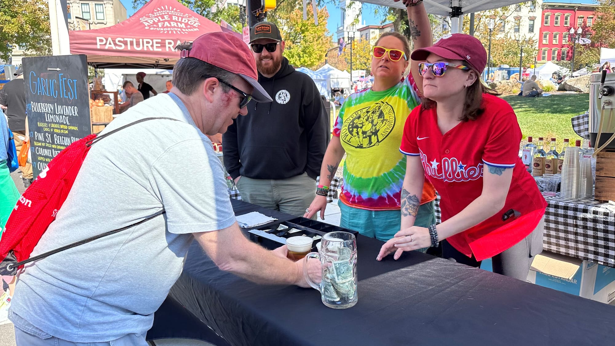 A customer orders a garlic beer from Two Rivers Brewing at Easton Garlic Fest.