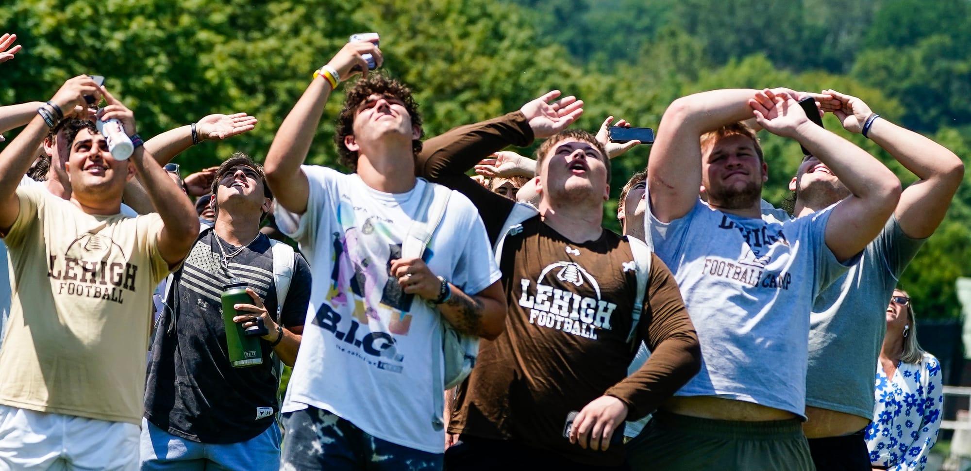 Members of the Lehigh football team watch as U.S. Special Forces members including U.S. Navy SEALs skydive from 4,000' onto t