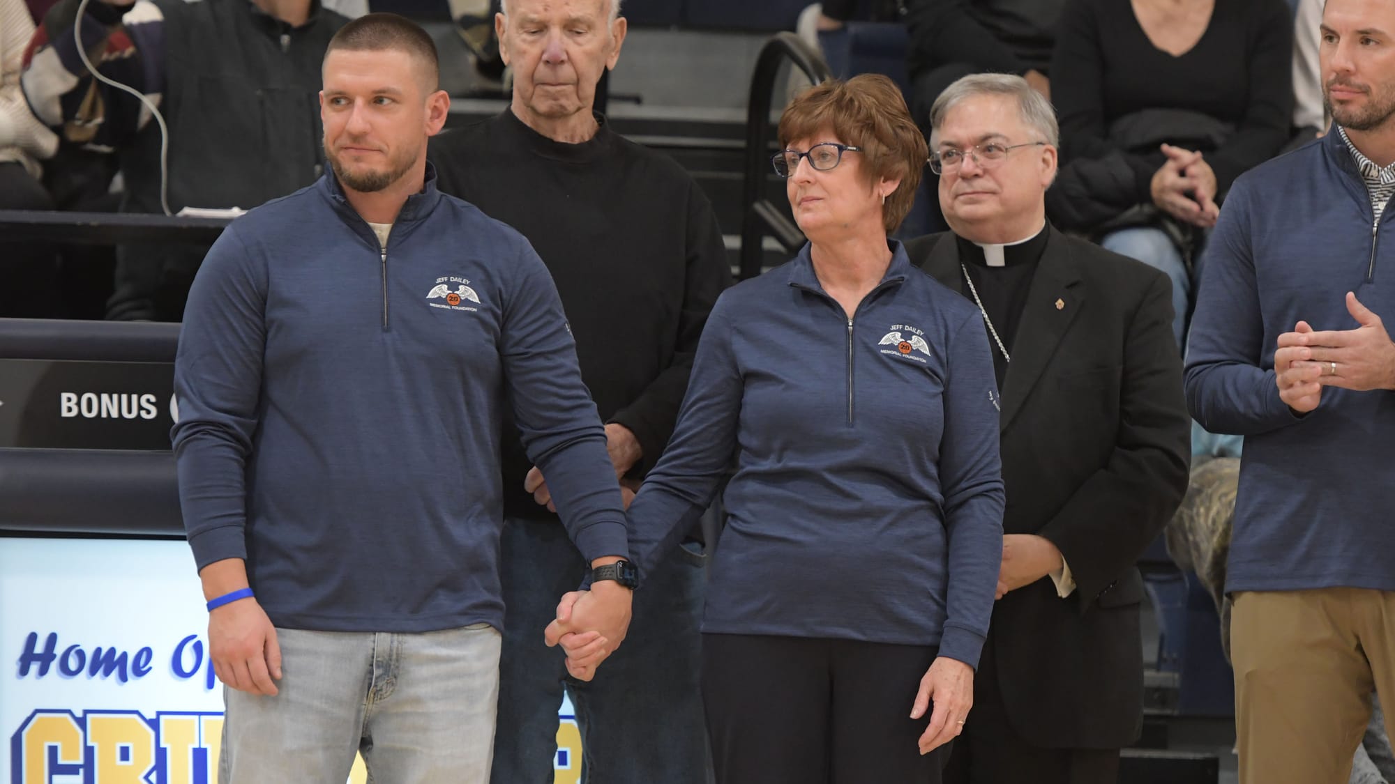 T.J. Dailey holds the hand of his mother, Jane Dailey during a court dedication for Jeff Dailey on Friday, December 1, 2023, 