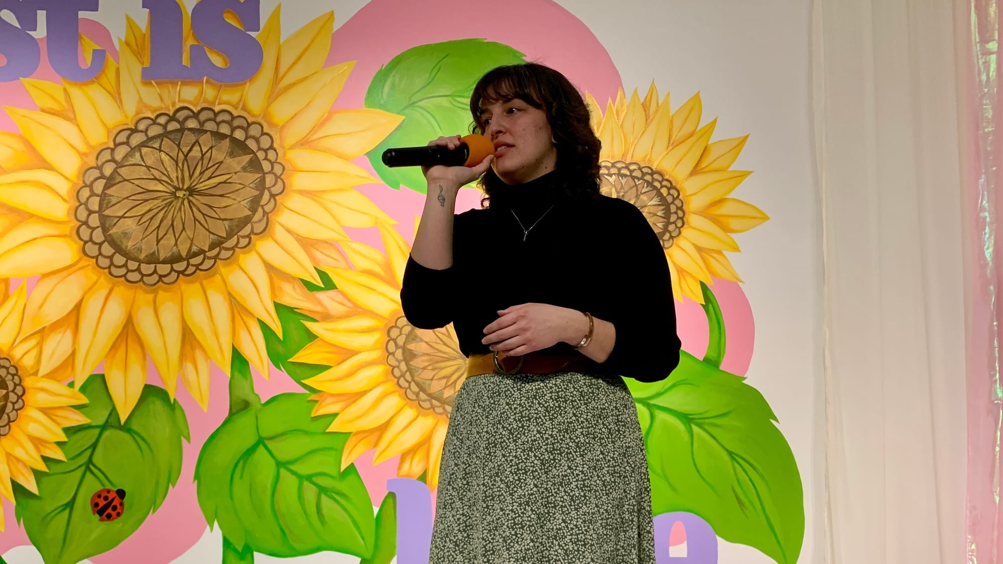 Artist Rozse, who is an Allentown native, performs during the 'Restoring Petals' reception.