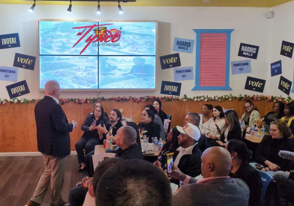 Democratic vice presidential candidate Tim Walz speaks with a group at El Tipico Restaurant at 410 W. Emaus Ave. in Allentown