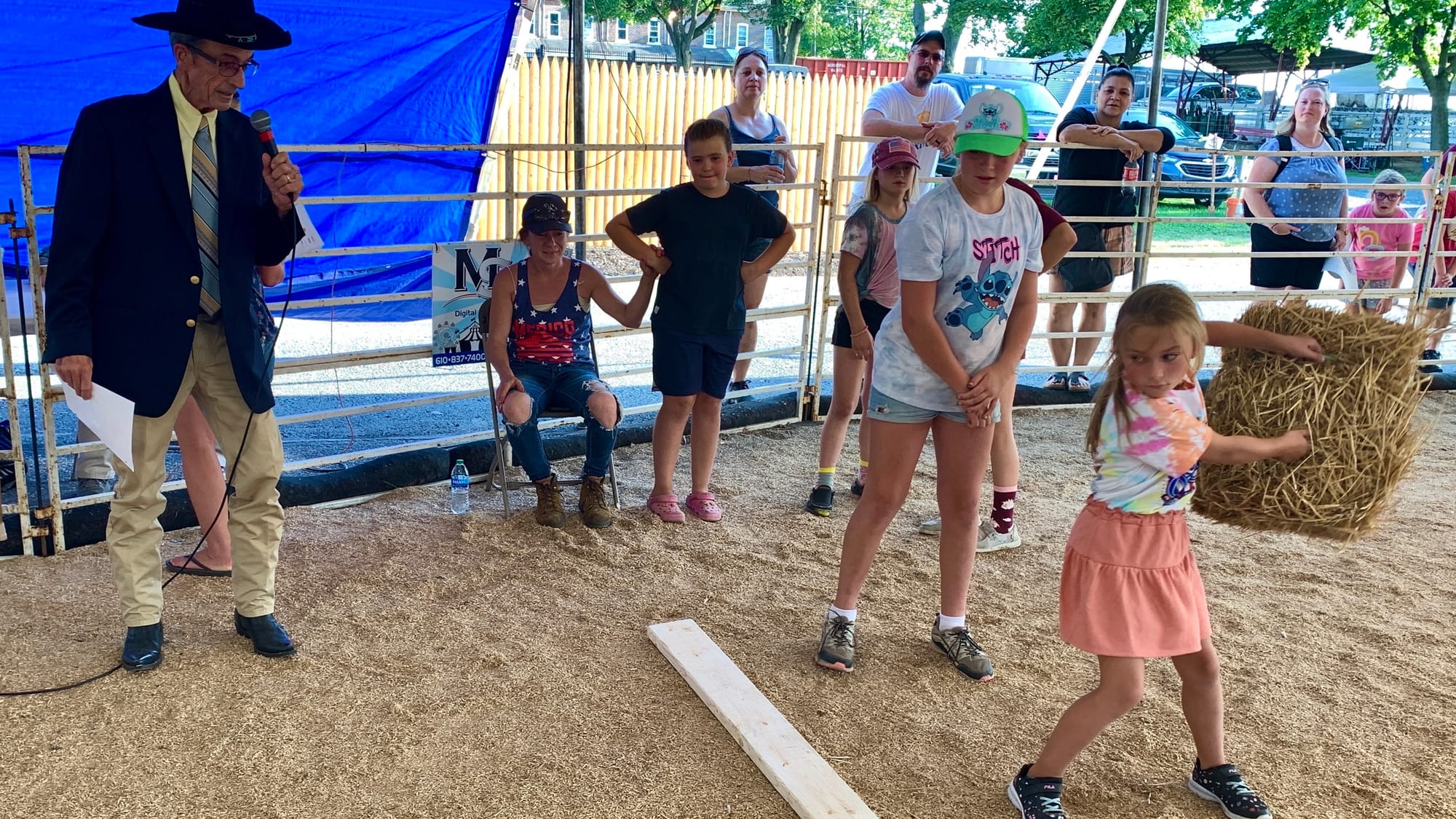 A competitor at the hay bale throwing competition at the Great Allentown Fair.